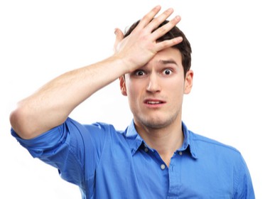 man slapping himself on the forehead