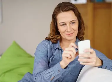 woman playing Intertops Casino Classic games on her phone