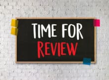 TIME FOR REVIEW on a chalkboard taped to the wall