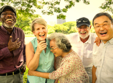 five senior citizens having fun at the park. the picture shows that having fun is a valuable goal in itself