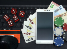 a smartphone with many of the accoutrements of online casino gaming such as dice, casino chips, and cards.