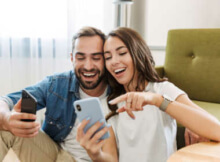 a young couple enjoying gaming together in their living room