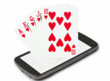 a Royal Flush in hearts emerging from a smartphone showing the value of online video poker