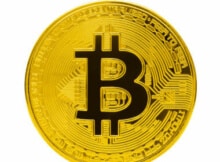 a large golden bitcoin on a white background with the B for bitcoin in black