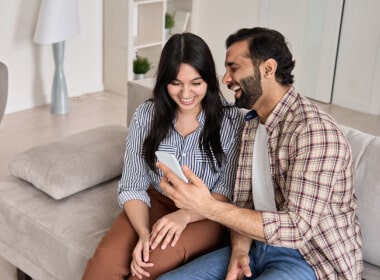 happy young couple enjoying online casino gaming while comfortable on the sofa