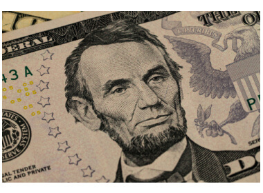 closeup view of Lincoln on a five dollar bill