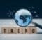 a magnifying glass magnifying the world as if from outer space and five blocks spelling trend